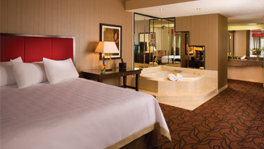 hotel suite with king bed and tub