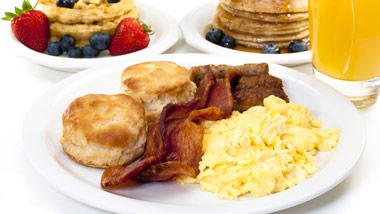 platter of eggs, bacon and biscuits